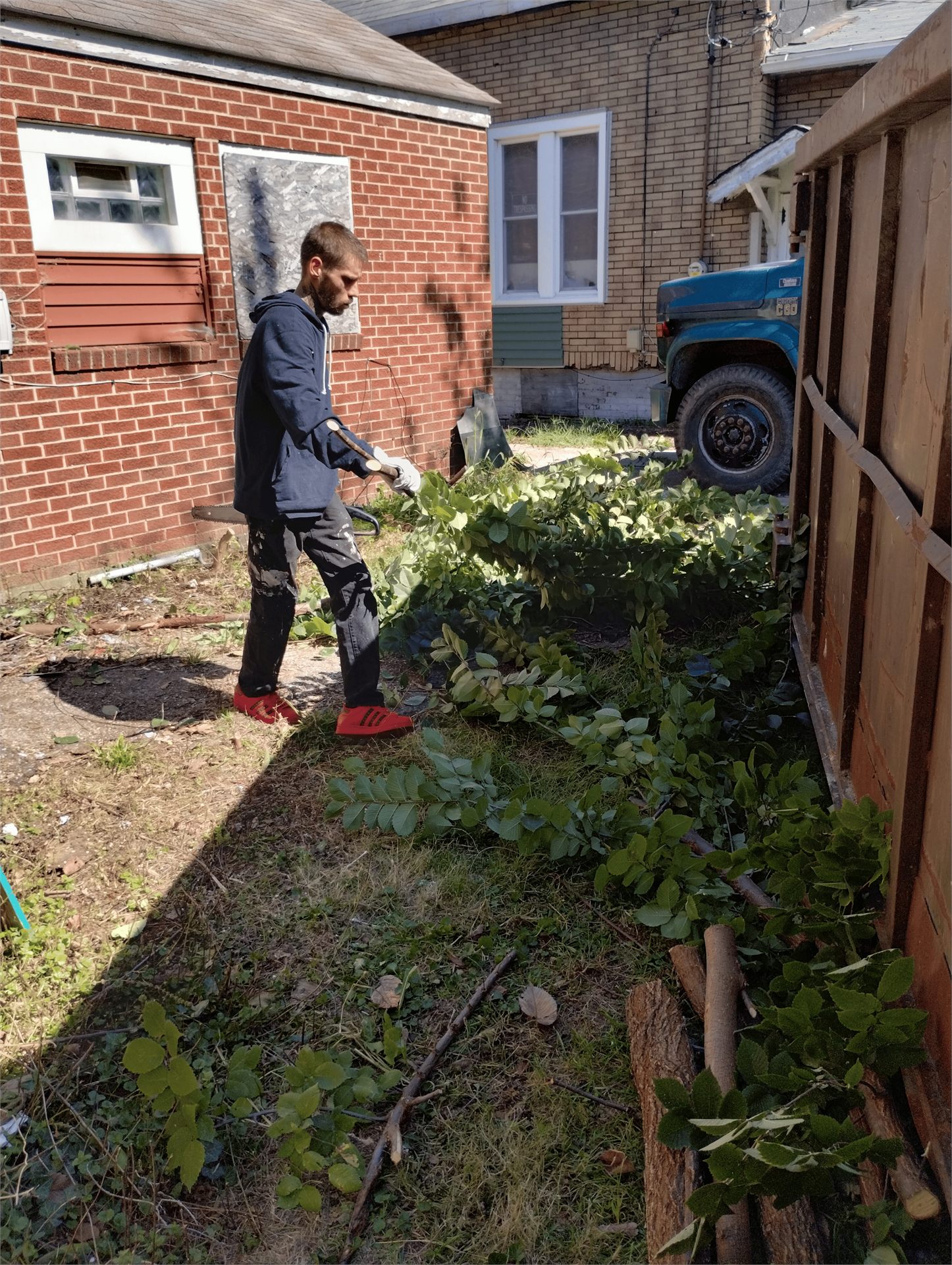 One Level participant doing cleanup work at a neighborhood project site